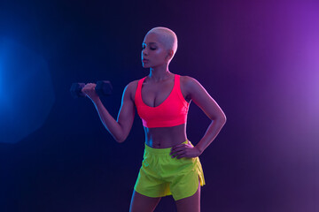 Sporty fit woman, athlete with dumbbells make fitness exercises on black background. Download cover for music collection for fitness classes. Sports recreation. Beautiful black young woman.