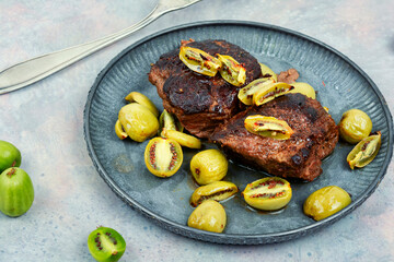 Grilled ostrich steak with kiwi berries