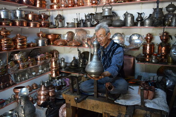 A tinsmith, in his, tinsmith's shop,The master, of working, with copper, in his shop