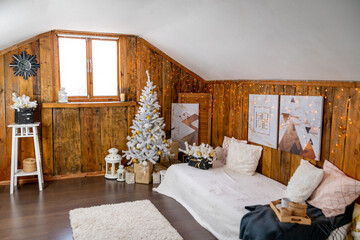 Christmas interior of the living room. The attic room of the house.