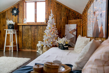 Christmas interior of the living room. The attic room of the house.