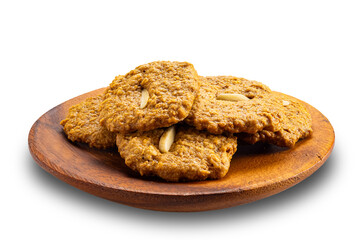 Delicious homemade crispy coconut cookies in wooden plate isolated on white background with clipping path.