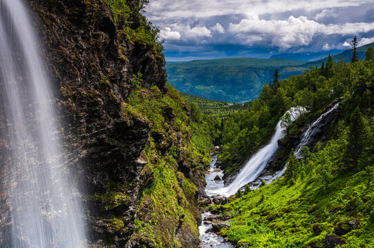 Waterfall in green mountain landscape