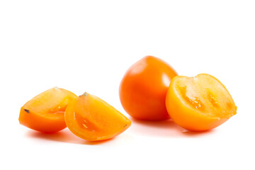 Cut and whole of yellow tomato isolated on white background.