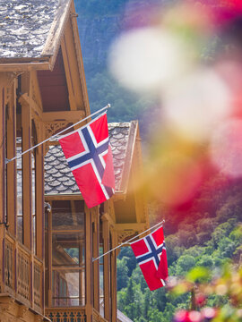 Low angle view of Danish flags at wooden house