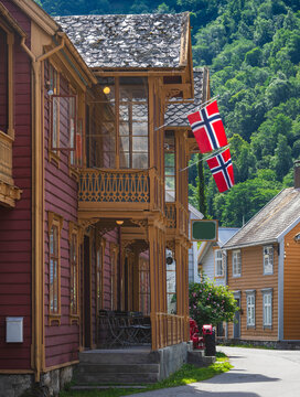 View of wooden house with Danish flags on porch