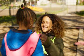 Volunteer playing with girl in park
