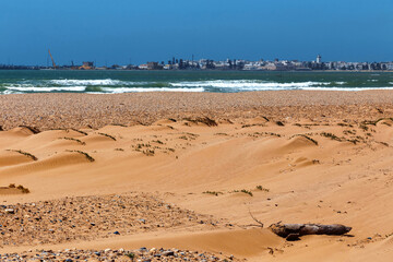 Picturesque view of the Essaouira resort from the golden sand beach of the African ocean coast. Morocco.