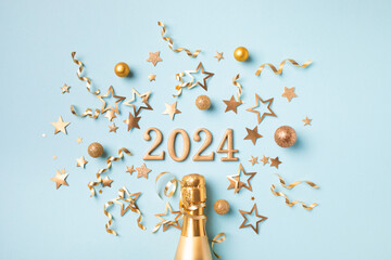 2024 golden champagne bottle christmas and New Year composition with party streamers, confetti...
