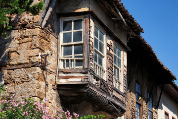 Fototapeta premium Old wooden windows in the one of the old ancient building of Kaleiсi. It is popular old historical quarter in Antalya. Turkey.