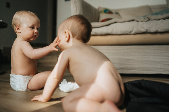 Naked Baby Siblings Playing At Home