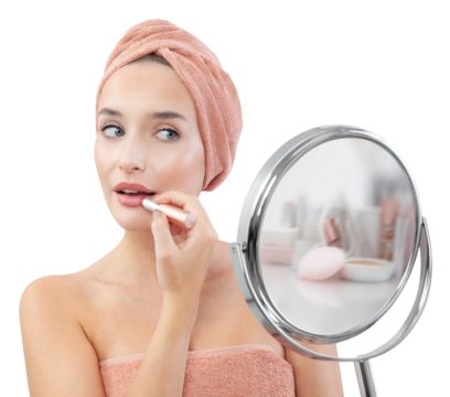 Makeup, smiling young pretty woman applying the red lipstick on the lips, wears a towel wrapped on head and with her big blue eyes looks at mirror that is held in hand. Isolated on white background