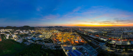 Panorama picture aerial view of the morning of the oil refinery from the drone of the tower of the Petrochemistry industry in the oil​ and​ gas​ ​industry with​ cloud​ sun orange​ sky.