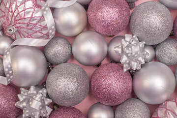 Christmas composition christmas silver and pink tree toys,christmas decoration at the pink background,top view photo.