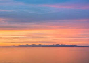 Naklejka na ściany i meble 穏やかな湖面：オレンジ、ピンク、青のグラデーションが広がる空と、その色が静かな湖面に反射し、地平線は山々のシルエットで描かれている、日の出または日没の風景