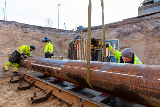 Metal workers working amidst iron pole at construction site