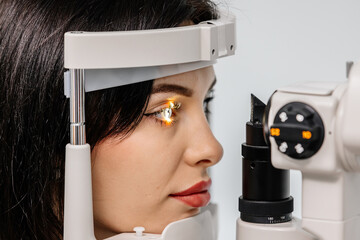 An ophthalmologist checks a young woman's vision using modern equipment. Concept for advertising...