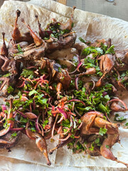 Dish with quails and greens