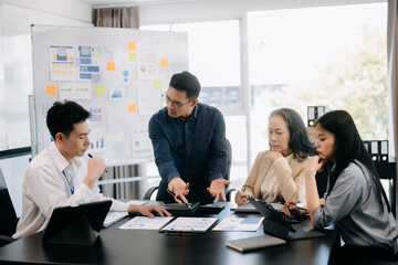 Furious two Asian businesspeople arguing strongly after making a mistake at work in office.