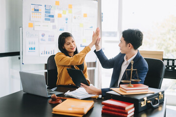 Asian business people and lawyers discussing contract papers sitting at the table. Concepts of law, advice, legal services