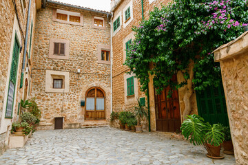 Fototapeta na wymiar Cozy courtyard with old traditional houses in a small village Fornalutx