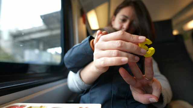Focused mother guiding her son in counting during a train journey, embodying the essence of homeschooling and childhood learning on-the-go