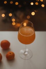 tangerine or orange juice with tangerines on the Christmas tree background 