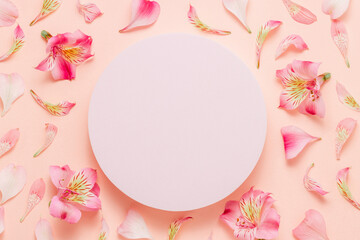 Product podium with pink flowers and petals, top view. Cute lovely background for cosmetic, perfume, design and product presentation.