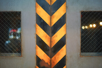 Yellow-Black striped on the rustic metal elevator gate at the factory warehouse, using as caution...