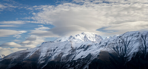 Mont-Blanc (covered by clouds) in the french alps covered with fresh snow, in winter. Megève, Haute-Savoie, France