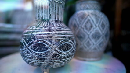 Intricate Ceramic Detail Traditional Vase in Focus on display behind glass. Handcrafted Beauty