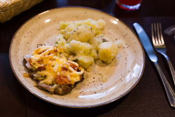 French meat with boiled potatoes served on plate