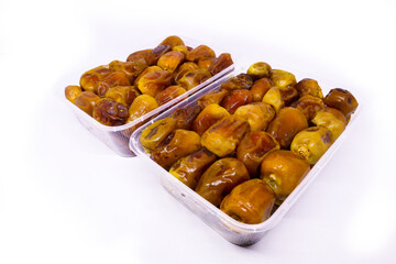 Close-up view of Two Transparent food container filled with piles of large delicious Sukkari dates to keep food hygienic side by side isolated on white background. Arabic healthy food concept.