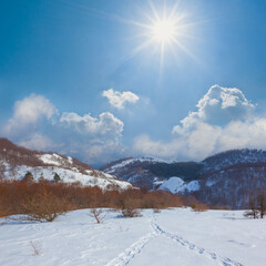 Fototapeta na wymiar snowbound mountain valley at the bright sunny day