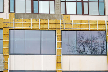 Building renovation, facade wall insulation, replacement of windows. Passive house wall heat...