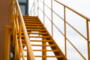 Banister handril with yellow painting of stairway platform at the factory place. Industrial...