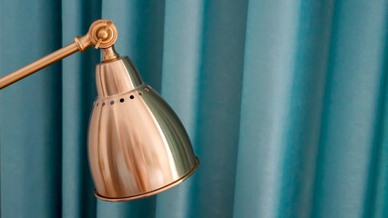 A vintage-looking gold bedside lamp