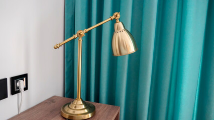 A vintage-looking gold bedside lamp