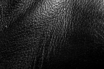 bright natural real black leather with Flexes dark waves background texture abstract close up,...