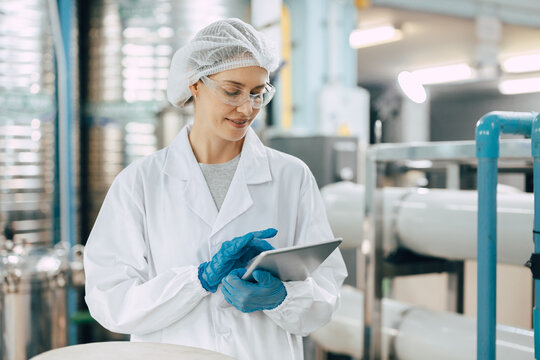Happy senior science staff women worker work control quality of water in drinking water plant using tablet to record jobs. - Powered by Adobe