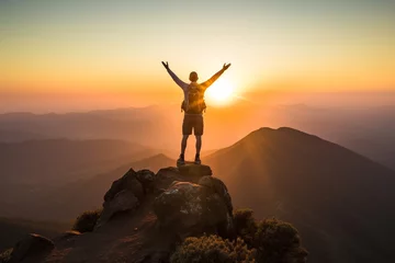 Fotobehang triumphant moment of mstanding at summit of mountain, with setting sun casting warm glow, vast expanse below, and sense of accomplishment and connection to natural world © Ruby