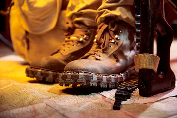 Military boots for mountainous terrain, on a military map.