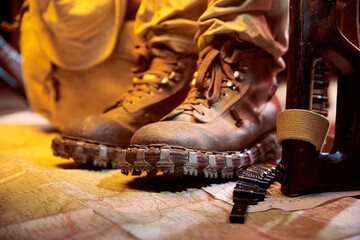 Military boots for mountainous terrain, on a military map.