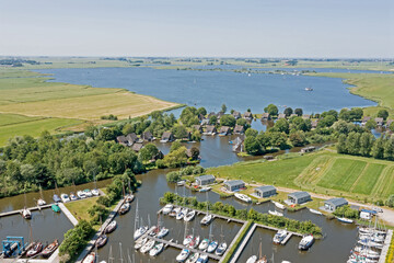 Fototapeta na wymiar Aerial from houses with boats in Friesland the Netherlands