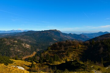View of Ratitovec mountain range above forest covered Jelovica plateau in Gorenjska, Slovenia