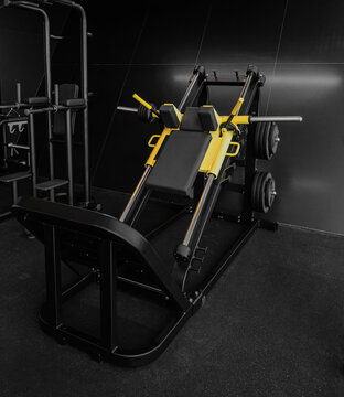 Squat machine in modern gym. Hack Squat