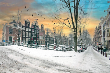 City scenic from snowy Amsterdam in the Netherlands at sunset