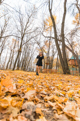 Diversity young beautiful confident Indian Asian woman in black dress in fall outdoor. Happy and natural smiling female. Generation z and gen z youth concept