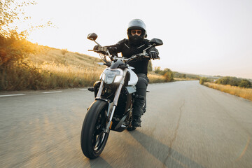 Man biker riding his motorbike on highway