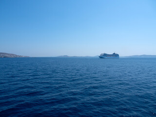 Large cruise liner in the sea port of Mykonos Island in Greece - obrazy, fototapety, plakaty